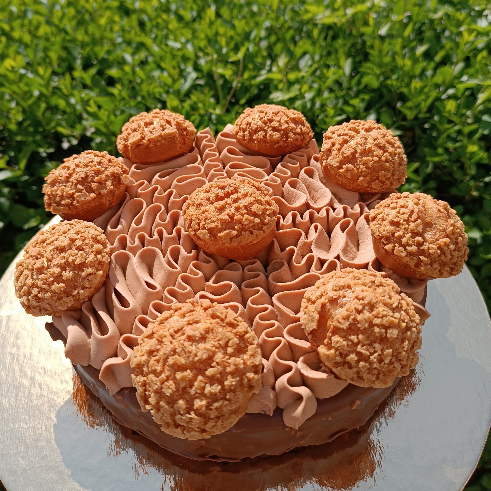 Celebration cake built with choux, piped cream and playful textured decoration