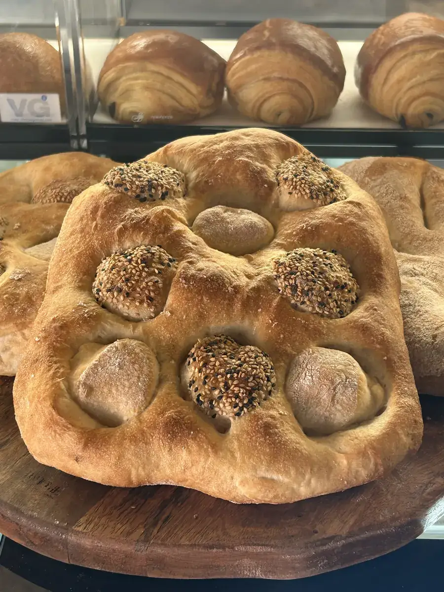 Round olive focaccia with olives set into its golden crust
