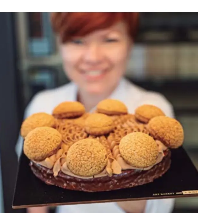 Round choux pastry with cream and small craquelin-topped choux puffs