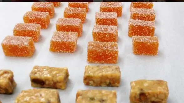 Small orange pâte de fruit pieces with a fine sugar coating
