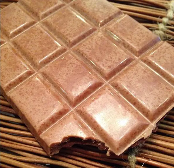Moulded chocolate tablets with geometric surfaces and a clean broken edge